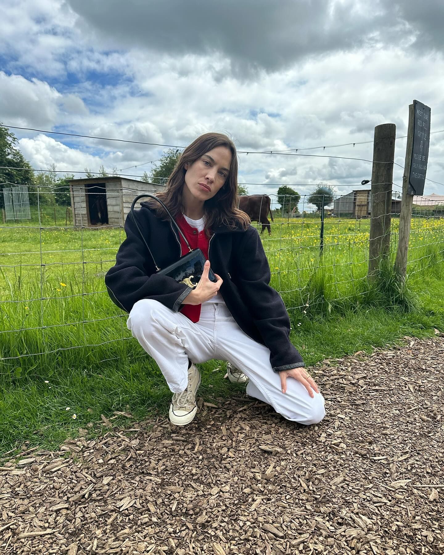 Alexa Chung wears cream high top converse.