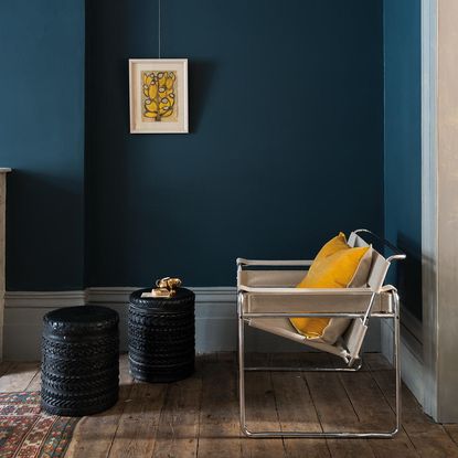 room with metal chair black tires on wooden floor