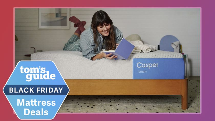 A woman sits on a Casper Dream Mattress on a bed frame in a bedroom, reading a book. In the bottom left corner, a Tom&#039;s Guide Black Friday mattress deals badge