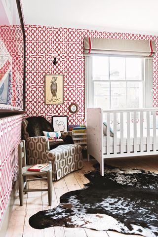 A nursery with bold wallpaper design