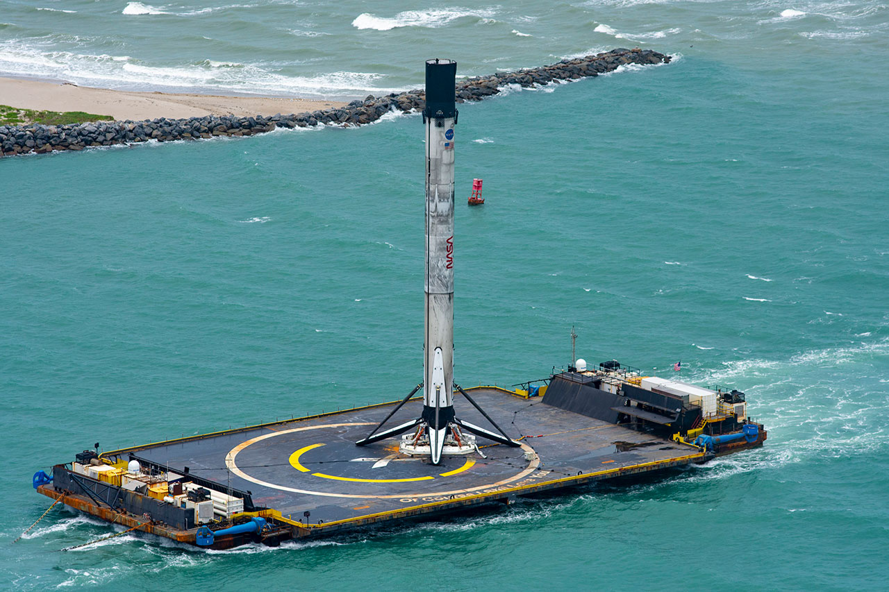 a booster sitting on top of a drone ship