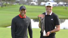 Genesis Invitational host Tiger Woods stands with 2024 winner Ludvig Aberg who holds the trophy
