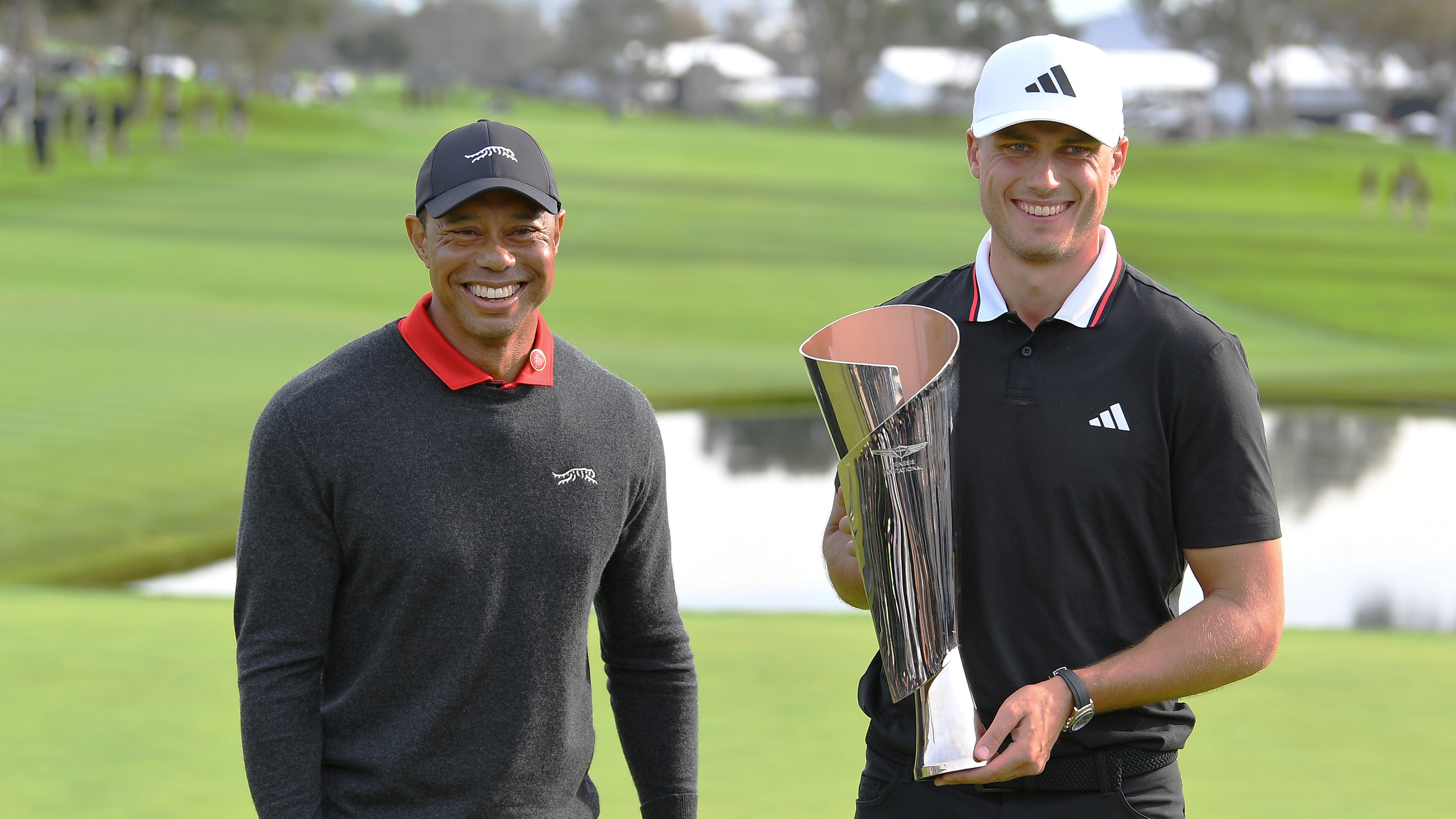 Genesis Invitational host Tiger Woods stands with 2024 winner Ludvig Aberg who holds the trophy
