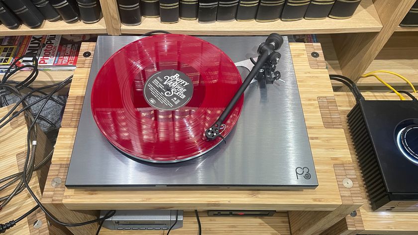 Rega Planar 3 RS Edition turntable on hi-fi rack playing pink vinyl record