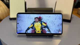 The Samsung Galaxy S25 Ultra stood in landscape orientation on a table. On screen is a fight scene from the film Deadpool Vs Wolverine.