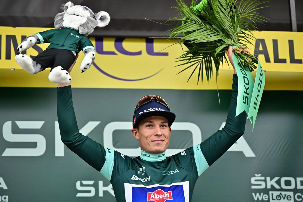 Alpecin-Deceuninck's Belgian rider Jasper Philipsen celebrates on the podium with the best sprinter's green jersey after winning the 11th stage of the 110th edition of the Tour de France cycling race, 180 km between Clermont-Ferrand and Moulins, in central France, on July 12, 2023. (Photo by Marco BERTORELLO / AFP)