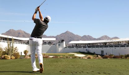 Ryan Palmer strikes a tee shot at the 16th hole at the Waste Management Phoenix Open