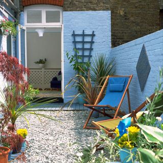 garden area with blue wall and plant pots