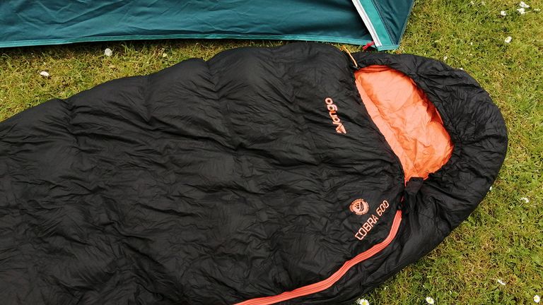 Vango Cobra 600 sleeping bag on some grass next to a tent