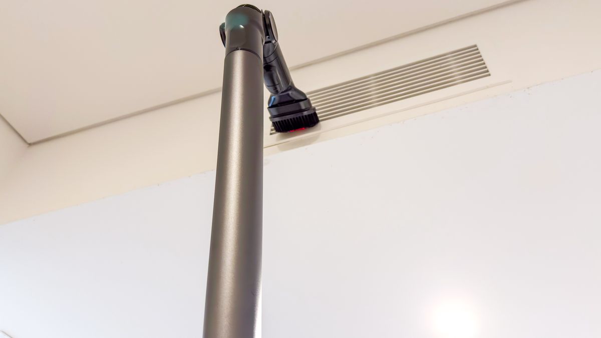 The Samsung Jet 95S Flex Tool and dusting brush against an air-conditioning vent