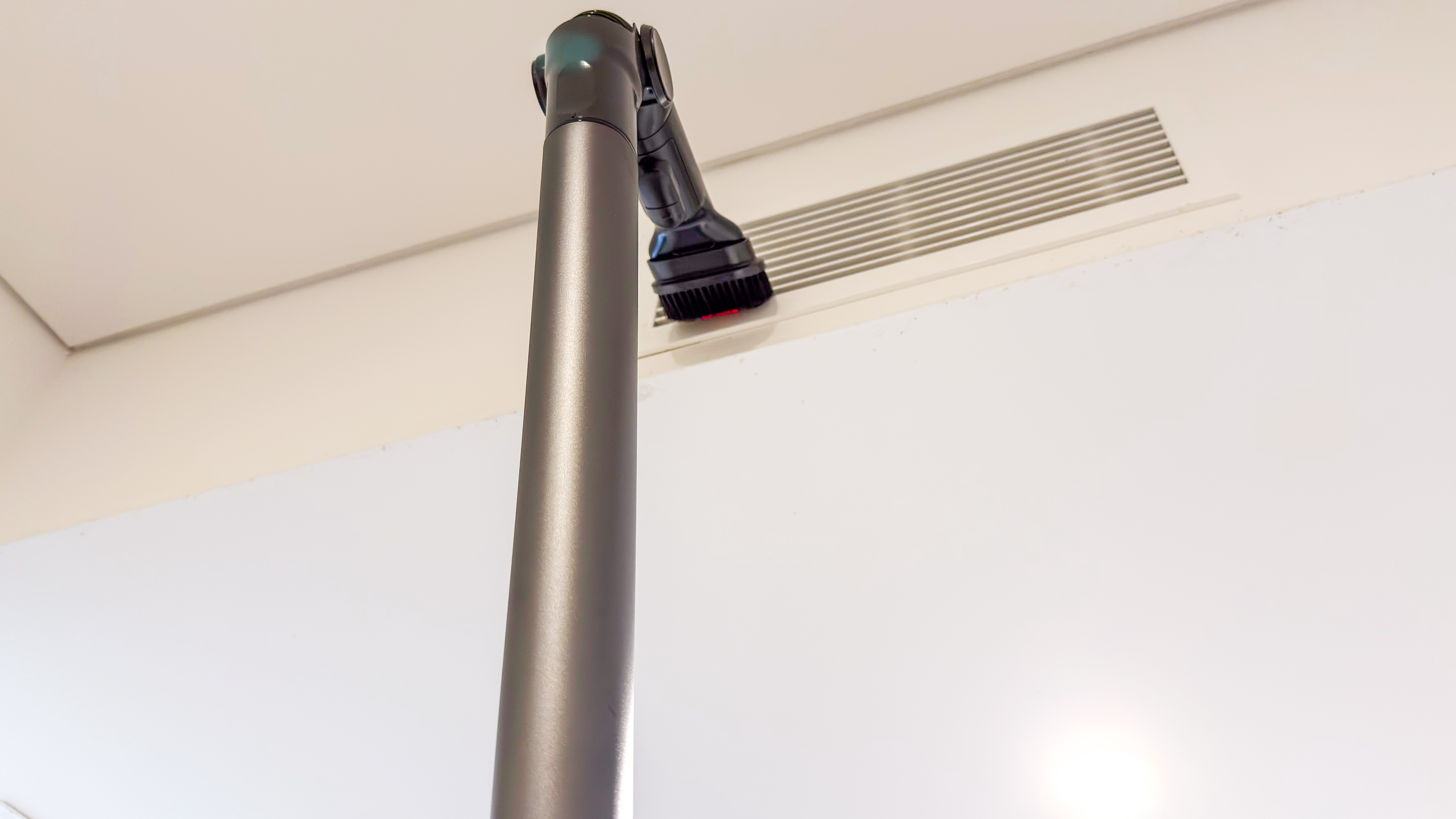 The Samsung Jet 95S Flex Tool and dusting brush against an air-conditioning vent