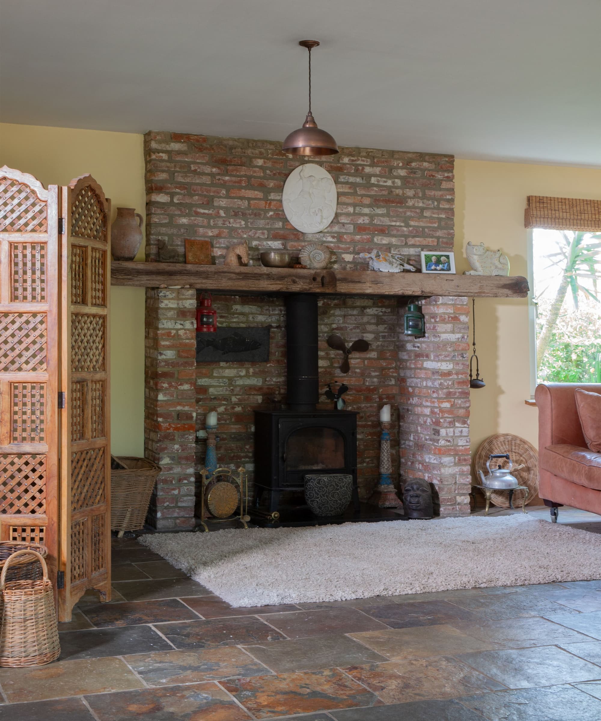 A woodburning stove with a brick surround