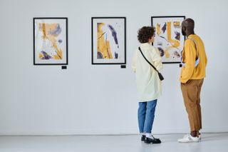 couple at an art gallery looking at a painting