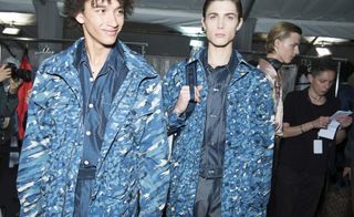 2 male models wearing blue camouflage print jackets