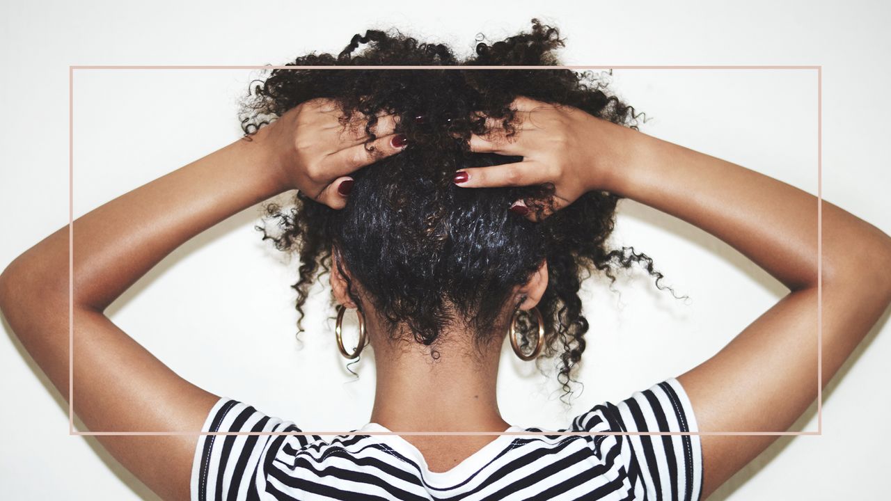 woman massaging her head to signify scalp massage for hair growth