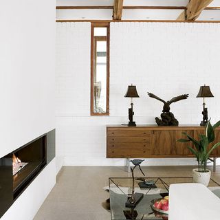living area with white wall and fireplace
