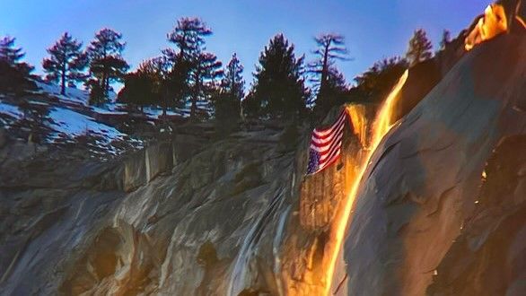 A US flag hangs upside down during the firefall in Yosemite