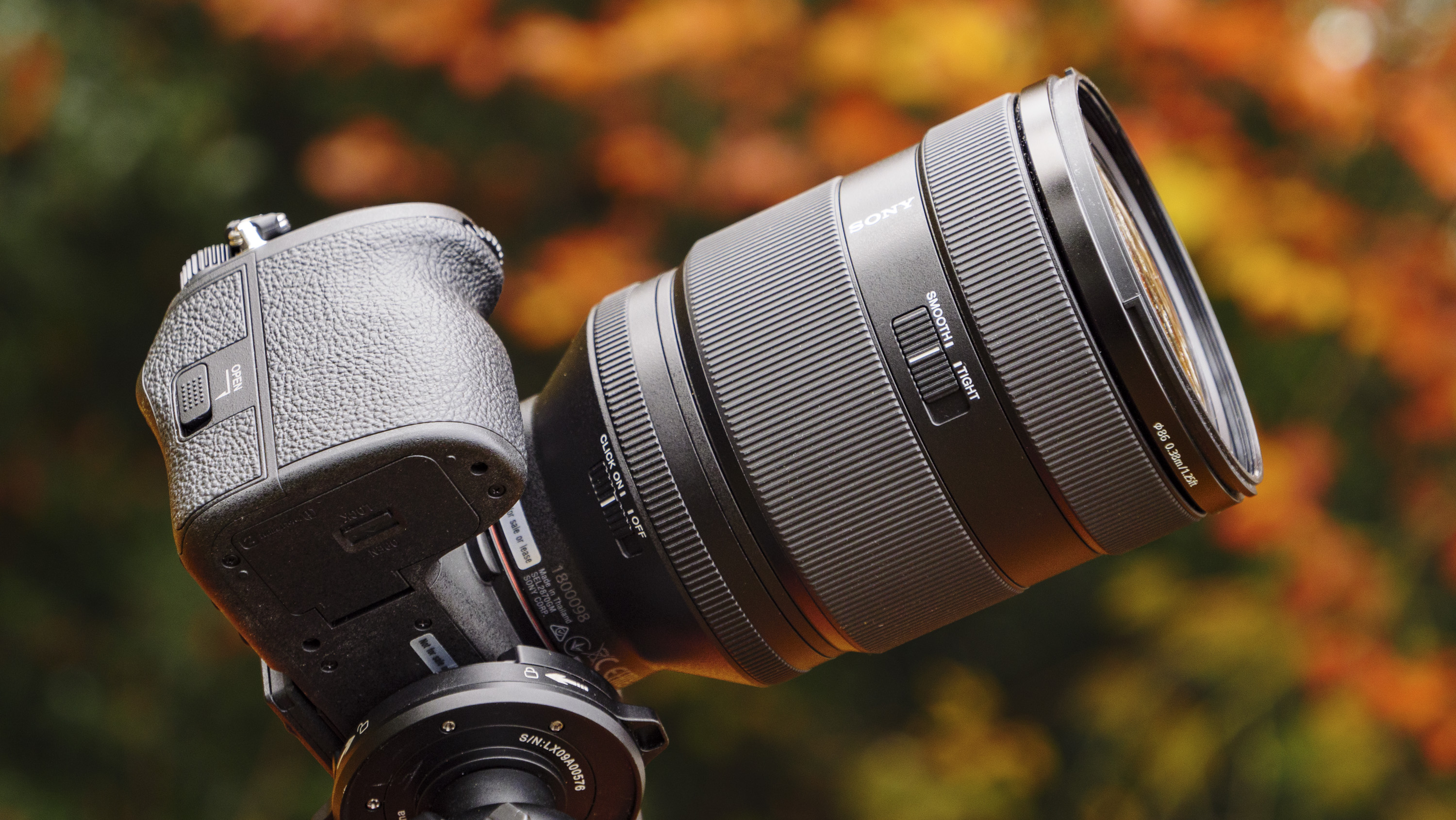Underside of the Sony FE 28-70mm F2 GM lens with its aperture dial customization switches