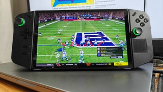 Lenovo Legion Go with Madden NFL 24 gameplay sitting on a silver laptop