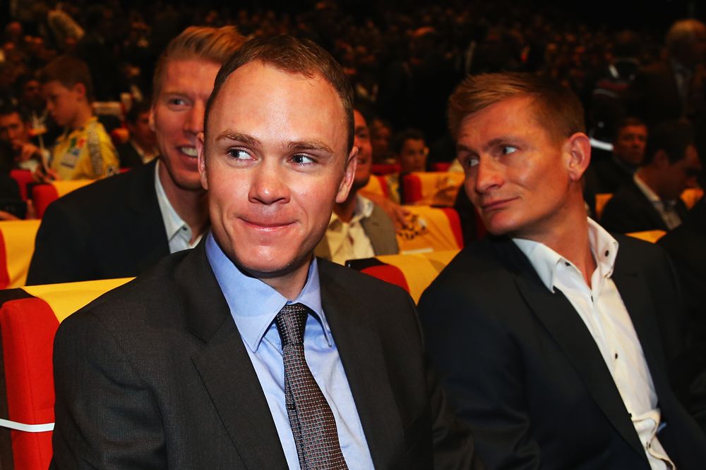 Chris Froome and other riders have a chuckle at something going on off-stage