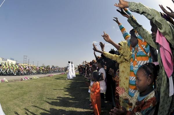 Spectators cheer the peloton in the Tour of Oman's first stage.