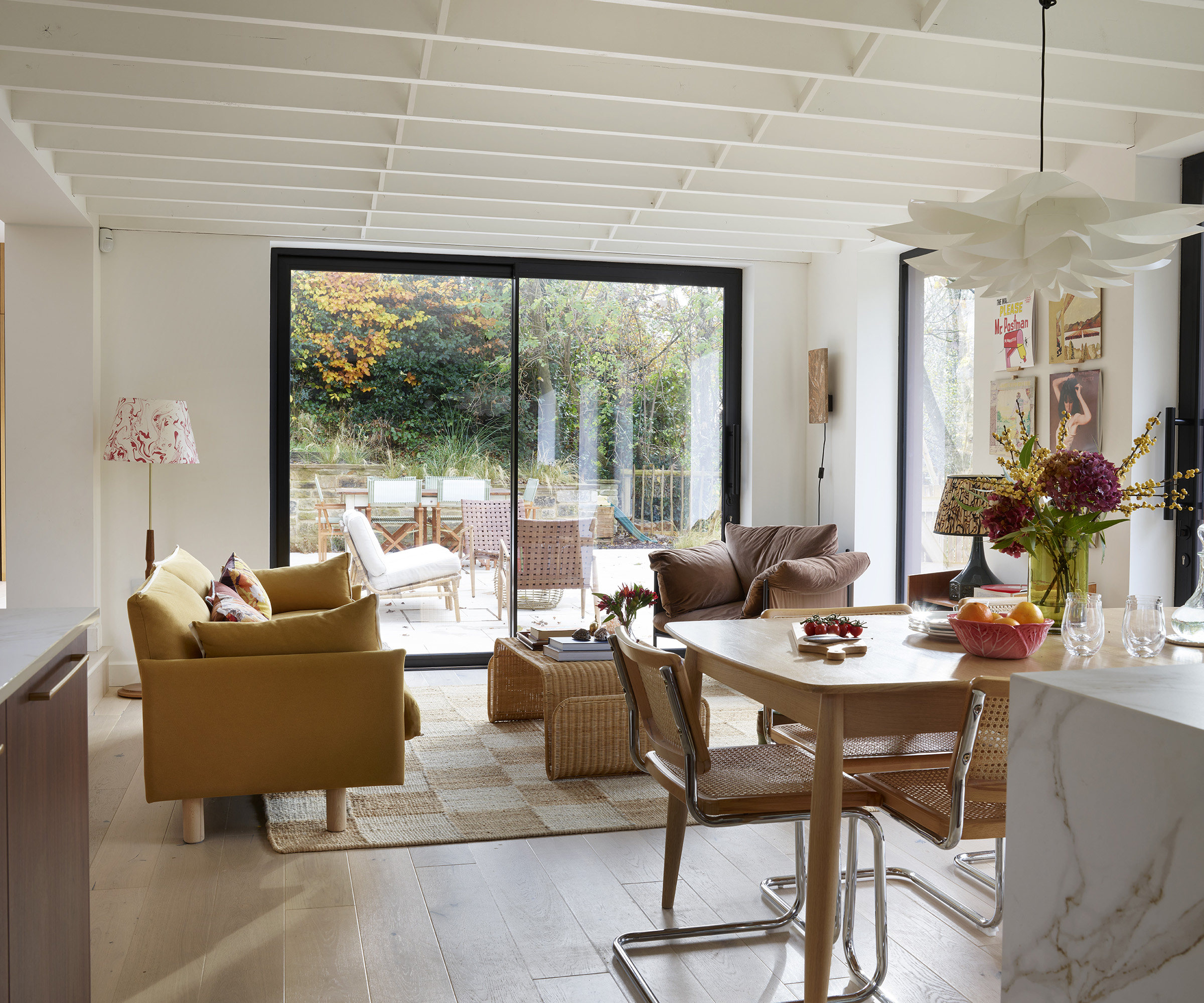 Living room with contemporary furniture with view s out of a black framed sliding door