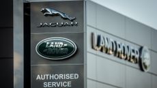 Jaguar Land Rover dealership with Jaguar and Land Rover logos pictured on a sign.