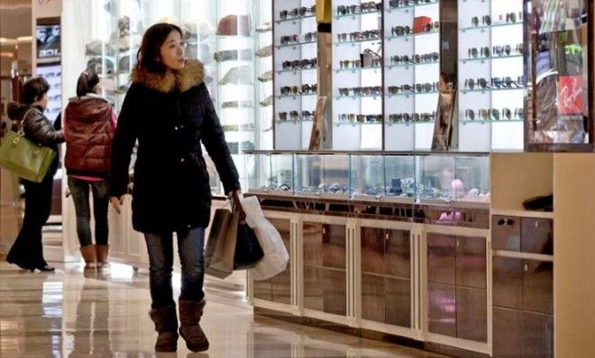 A woman shops in a Beijing mall: &amp;quot;The economy has officially exited its slowdown,&amp;quot; Chinese officials said.