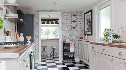 kitchen with black and white tiles and wooden worktop
