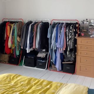 bedroom with clothes on clothes rails