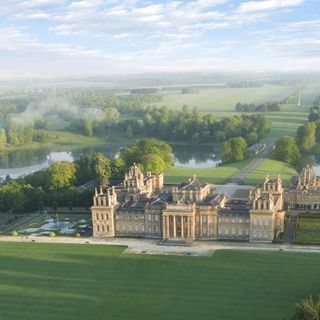 blenheim palace with trees and lawn area