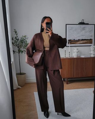 @femmeblk wearing a brown suit