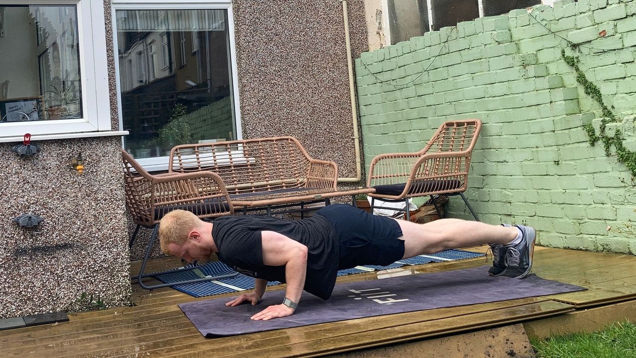 Fit&amp;Well fitness writer Harry Bullmore performing a push-up as part of an Arnold Schwarzenegger bodyweight workout challenge