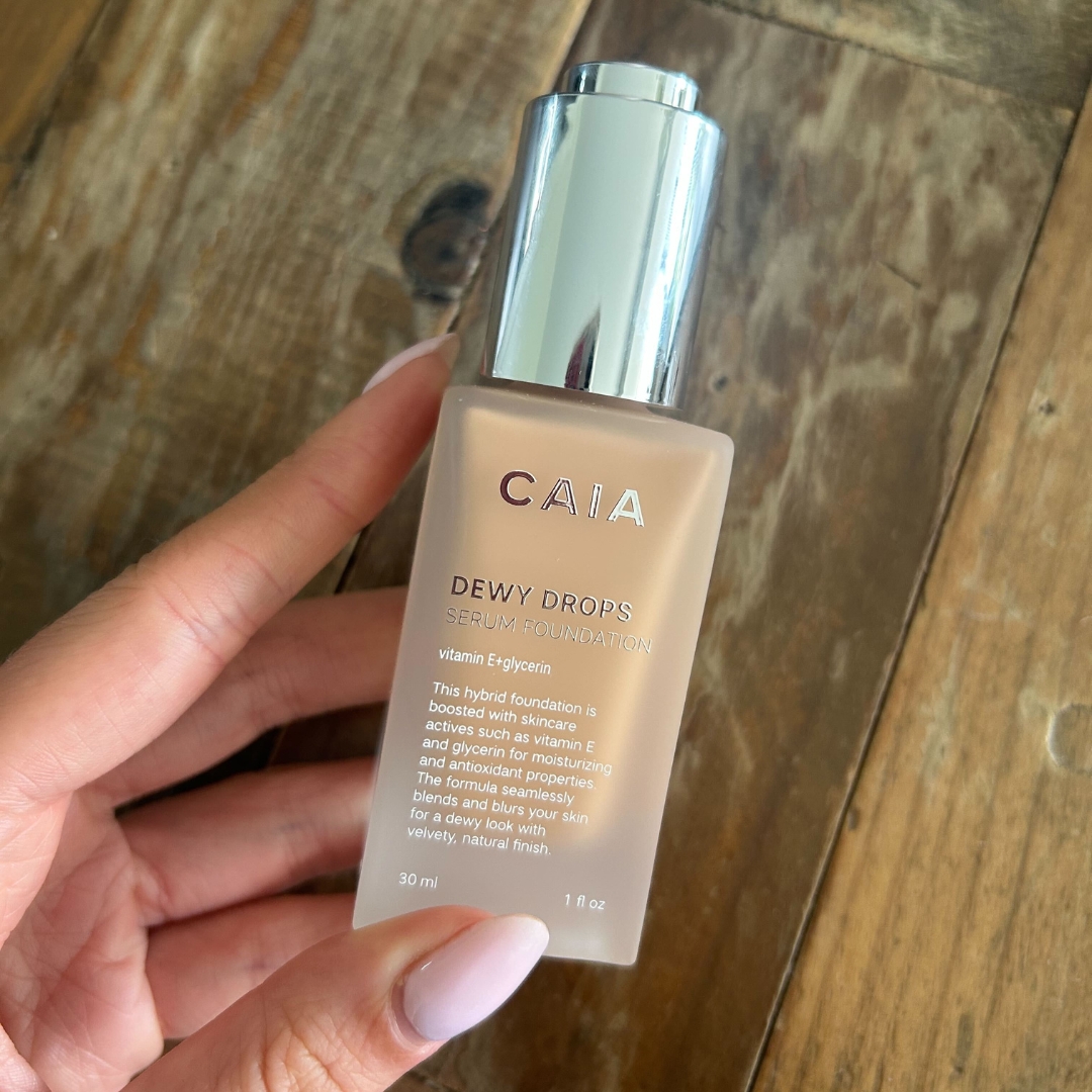 Hand holding the CAIA Dewy Drops Serum Foundation