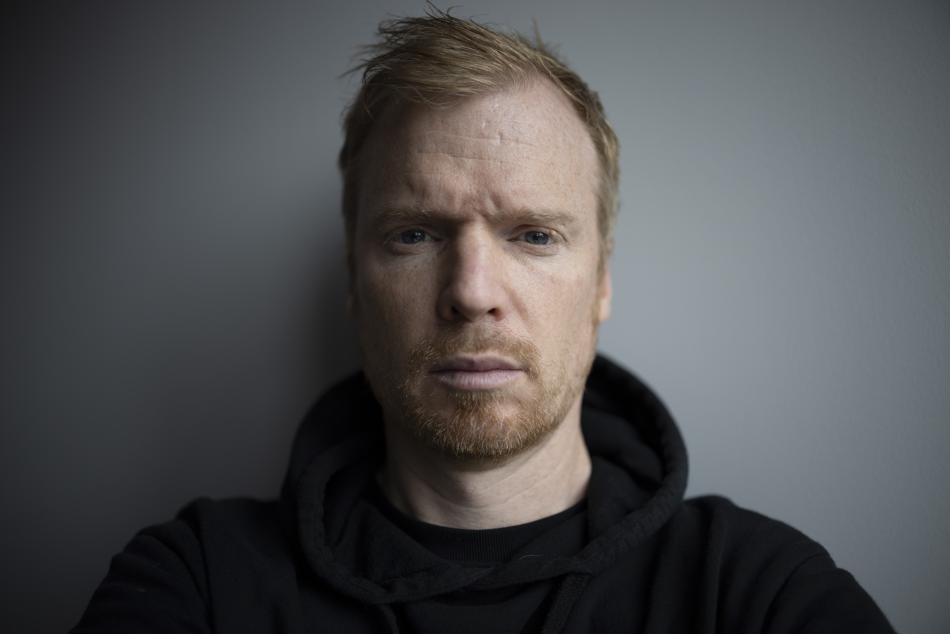 Self portrait against a gray wall, taken with the Canon RF 35mm F1.4L IS VCM lens
