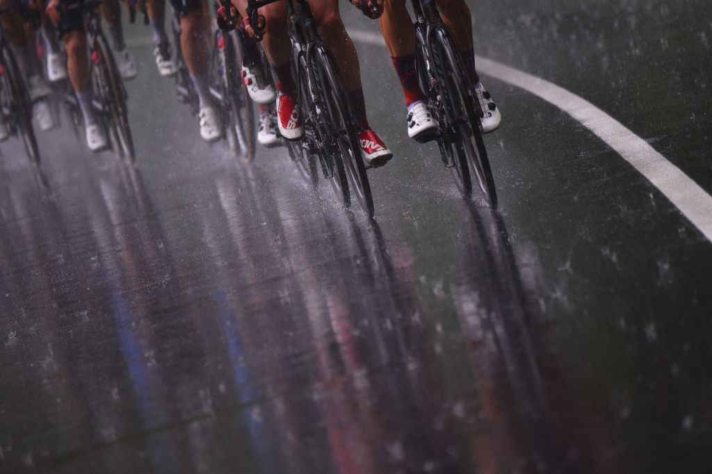 TOPSHOT The pack rides under the rain during the sixth stage of the Giro dItalia 2021 cycling race 160 km between Grotte di Frasassi and Ascoli Piceno San Giacomo on May 13 2021 Photo by Dario BELINGHERI AFP Photo by DARIO BELINGHERIAFP via Getty Images