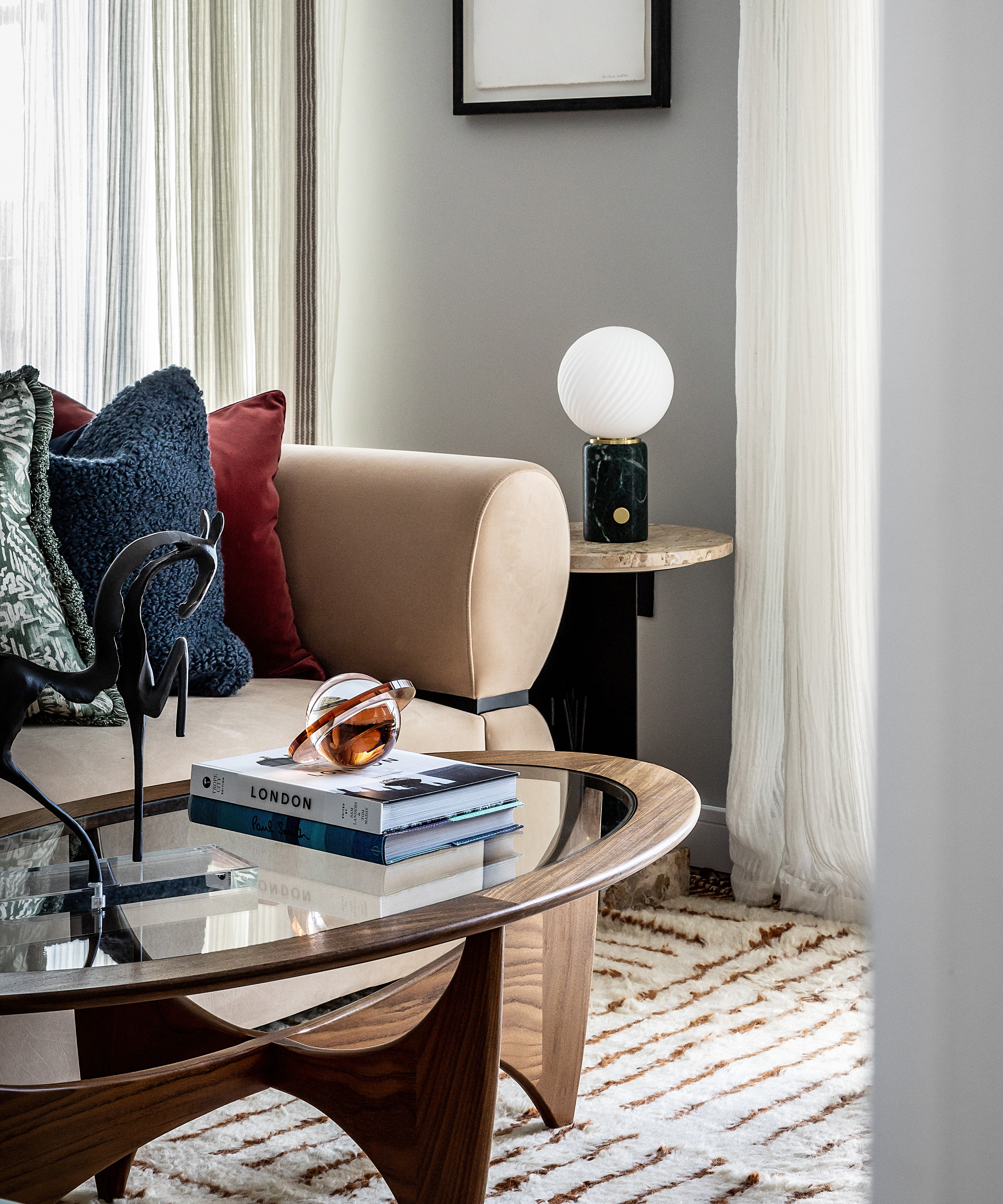 round g plan wood coffee table in a modern living room with books on it