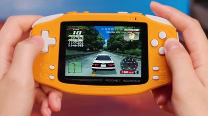 Hands using KONKR Pocket Advance in coral (spiced orange) to play Initial D Special Stage.