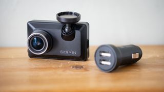 Garmin Dash Cam X210 on a wooden surface