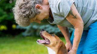 Dog looking up at owner appearing to show respect