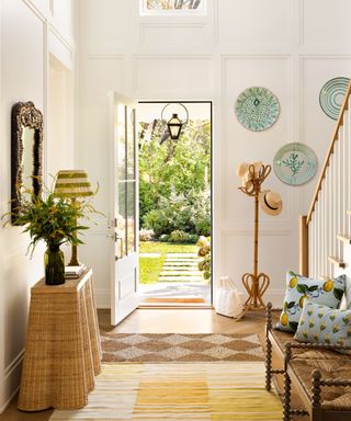 Light entryway with green and yellow decor and bench