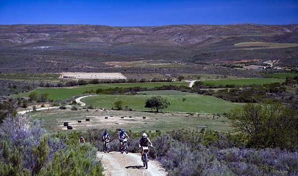 Racers crest a hill.