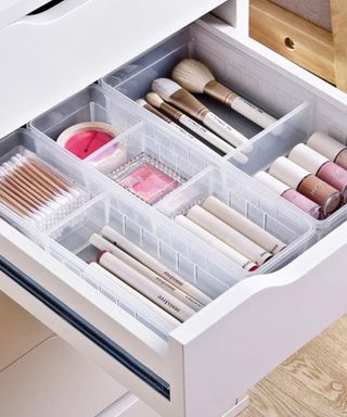An image of an open drawer showing beauty items neatly organized in trays