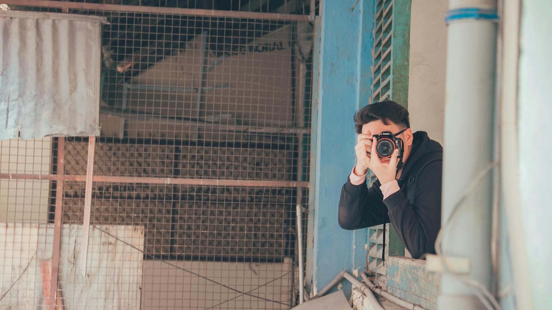 Man holding DSLR camera
