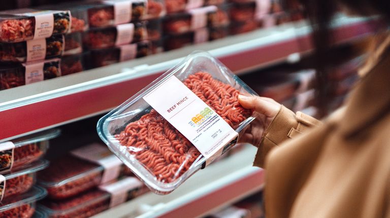 Woman holding packaged red meat