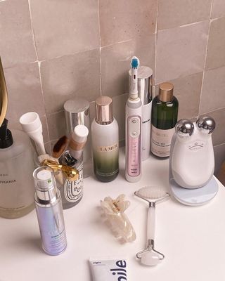 Emma Hoareau's vanity featuring beauty favorites from nuFace, La Mer, Diptyque, and more