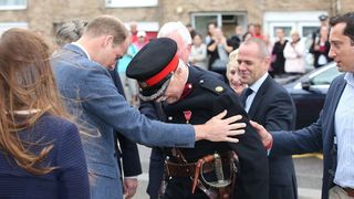 Prince William helps eldery man