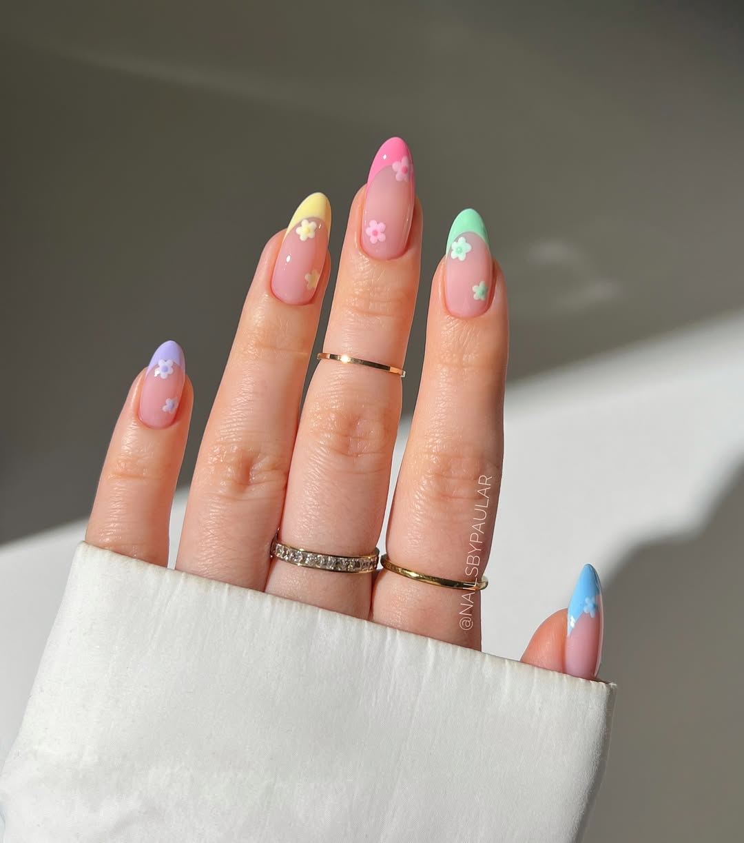 a rainbow french manicure with flowers