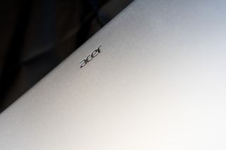 An Acer Swift Go 14 OLED laptop on a black background
