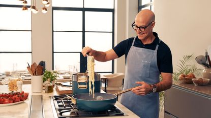 Stanley Tucci cooking with pan